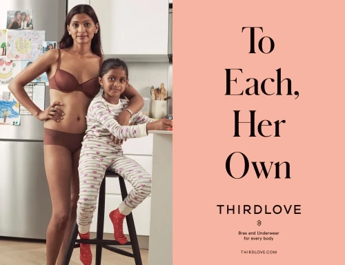 Mother and daughter pose in kitchen; mother in lingerie, daughter in pajamas, next to ThirdLove ad. Supportive family theme.