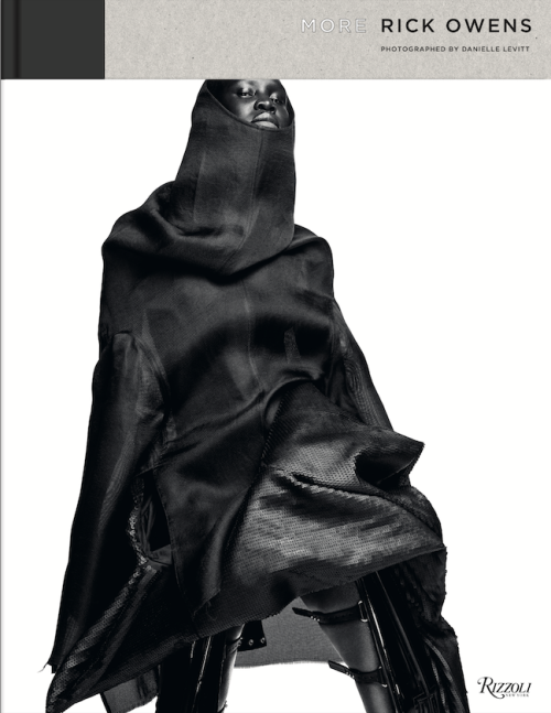 Fashion photography showcasing 'More Rick Owens' book cover, featuring a model in a dark, draped hooded garment against a white background.
