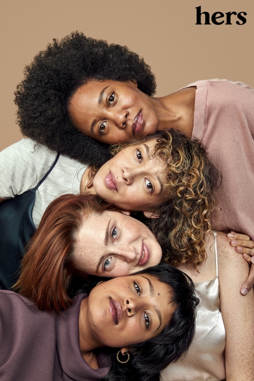 Close-up studio portrait of four diverse young women lying together. Tan background, natural lighting, soft color palette, modern style, 'hers' logo visible.