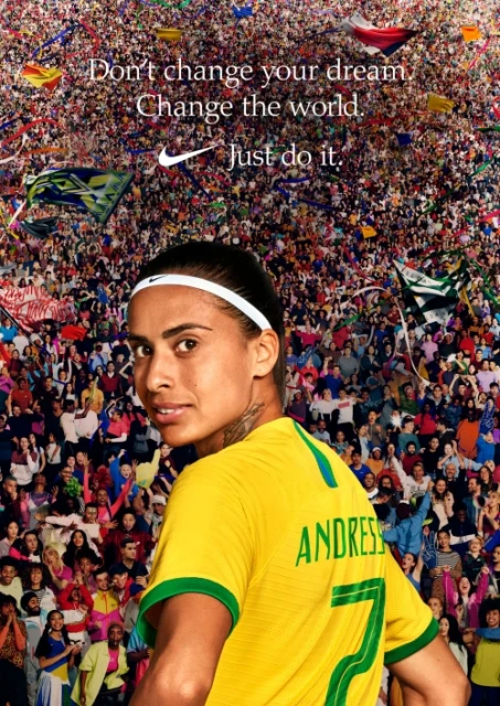 Portrait of a soccer player wearing a yellow jersey with a crowd of people and the Nike logo in the background and text overlayed.