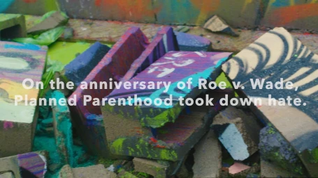 Close-up of brightly painted broken concrete blocks and rubble with vibrant graffiti colors.