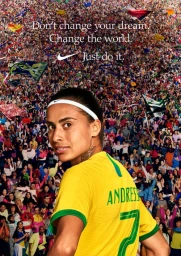 Female soccer player in a yellow jersey looking back against a dense crowd background under text overlay