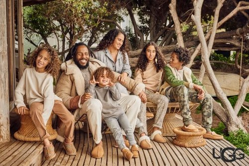 Family of six outdoors on a wooden deck wearing shearling jackets and slippers directed by Danielle Levitt