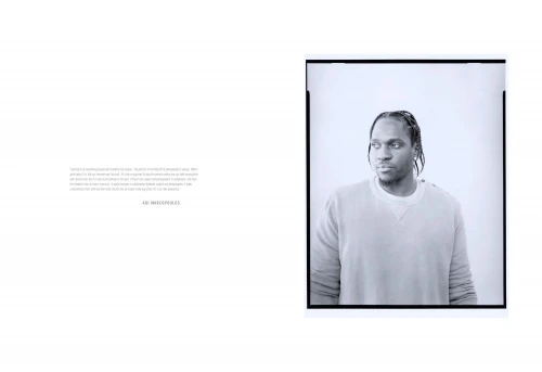 Black-and-white portrait of an adult male in a sweatshirt, looking off to the side, framed by a black border on a white background.