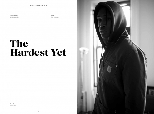 Black and white portrait of a black man wearing a hooded jacket indoors by a window, photographed by Ari Marcopoulos.