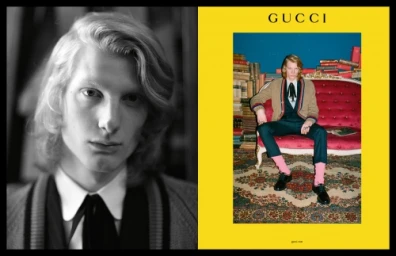 Gucci fashion editorial featuring a young male model seated on a red velvet couch in a room lined with books, photographed by Ari Marcopoulos.
