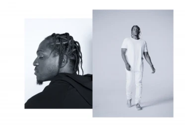 Black and white editorial portrait of a man with braided hair by photographer Ari Marcopoulos in New York