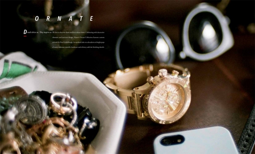 Elevated shot of a gold wristwatch beside sunglasses and jewelry in a white dish on a dark wooden surface, showcasing luxury accessories.