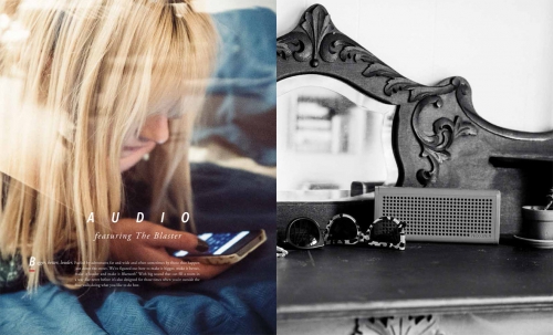 Young woman on phone relaxing indoors with blonde hair; speaker, sunglasses, vintage vanity detail create monochrome contrast.