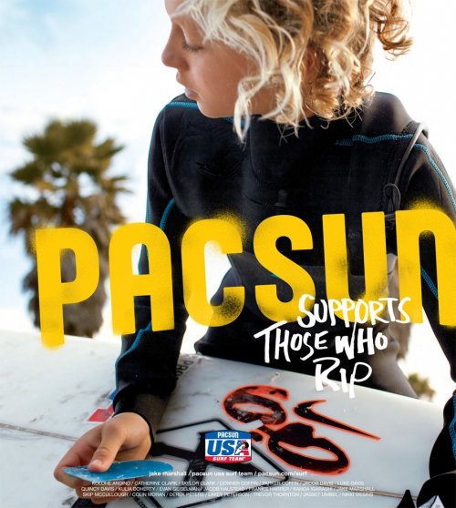 Teenager with blond hair in a wetsuit, holding a surfboard with the PacSun logo, palm trees and blue sky are in the background.