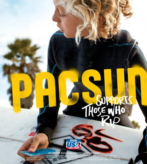 Teenager with blond hair in a wetsuit, holding a surfboard with the PacSun logo, palm trees and blue sky are in the background.