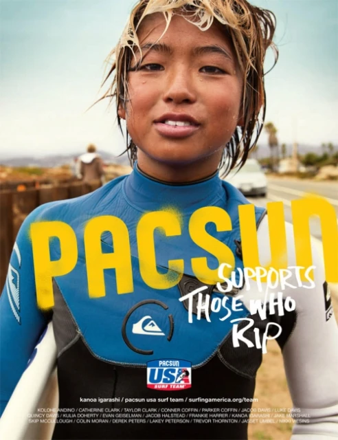 Close-up of a young surfer with wet hair, PacSun logo prominently displayed, wetsuit detail, and a blurred beach background in daytime.