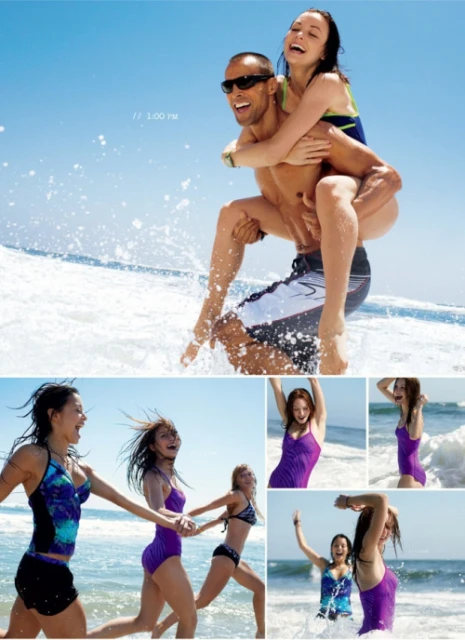 Woman riding piggyback on a man on a beach near ocean waves. Several other women are running and playing on the beach.