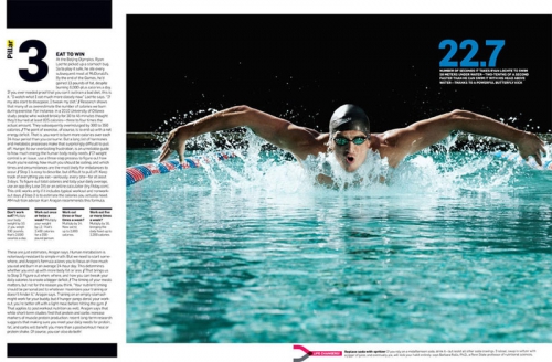 A swimmer is captured mid-stroke in a pool. The person is wearing goggles and a swim cap, with water splashing around them.