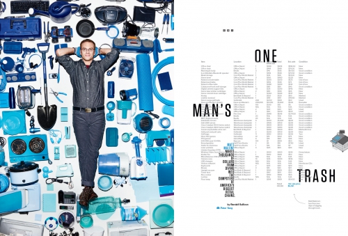 Adult man poses amidst a collection of blue objects against a white background in a studio photograph. The composition is clean and organized.