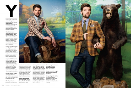 Adam Scott poses in a plaid blazer with a bear statue; he's also sitting on a tree stump in another photo for magazine editorial.