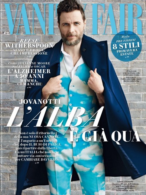 Magazine cover featuring a man wearing a cloud-patterned suit and blue coat. The cover includes Vanity Fair logo and various Italian text.