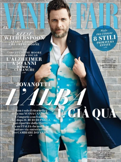 Magazine cover featuring a man wearing a cloud-patterned suit and blue coat. The cover includes Vanity Fair logo and various Italian text.