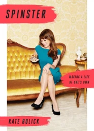 Woman in a blue dress seated on a yellow tufted settee holding a teacup, photographed by Peter Yang.