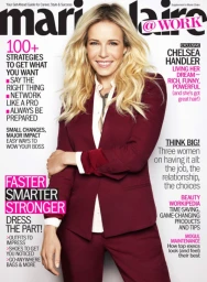 Blonde woman wearing a burgundy suit jacket and trousers posing against a bright white background