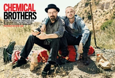 Bryan Cranston and Aaron Paul posing outdoors in a desert landscape for a magazine portrait photographed by Peter Yang.