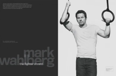 Mark Wahlberg holding gymnastics rings wearing a white t-shirt and dark jeans in a black and white portrait by Peter Yang