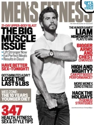 Liam Hemsworth on Men's Fitness magazine cover wearing a white t-shirt and jeans against a white background.