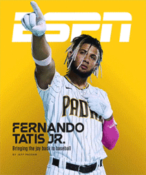 Fernando Tatis Jr wearing a Padres baseball uniform pointing upward against a solid yellow background