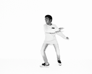 Young black man in a long-sleeve t-shirt and jeans dancing against a white background