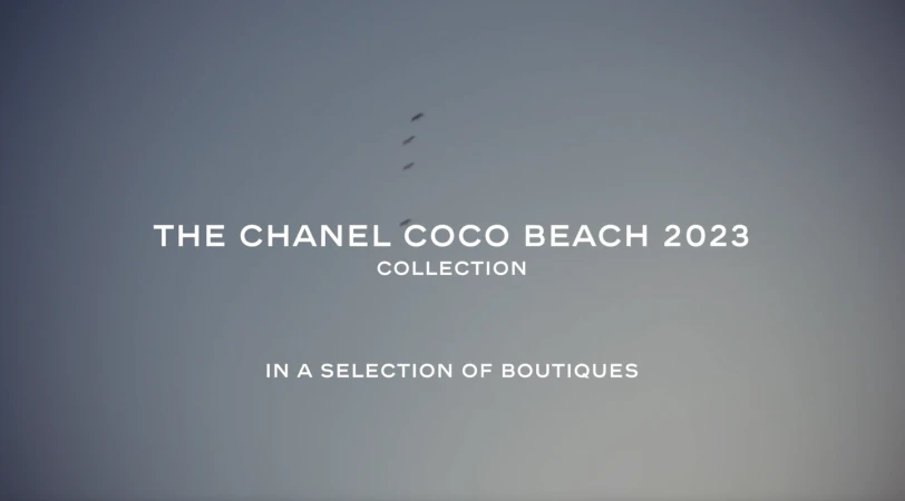 Coco Beach 2023 collection ad against a gradient gray-blue sky backdrop, featuring birds flying and promotional text for a fashion collection.