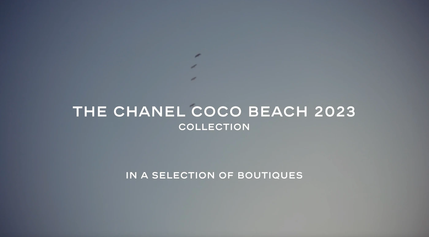 A soft gradient sky background displaying crisp white promotional typography for the Chanel Coco Beach 2023 collection.