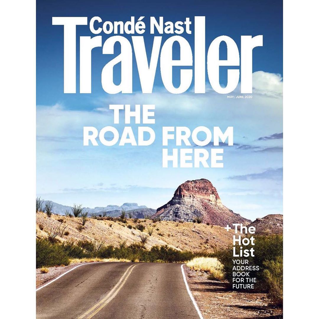 Condé Nast Traveler magazine cover featuring a desert road leading to a mesa against a blue sky with text overlay.