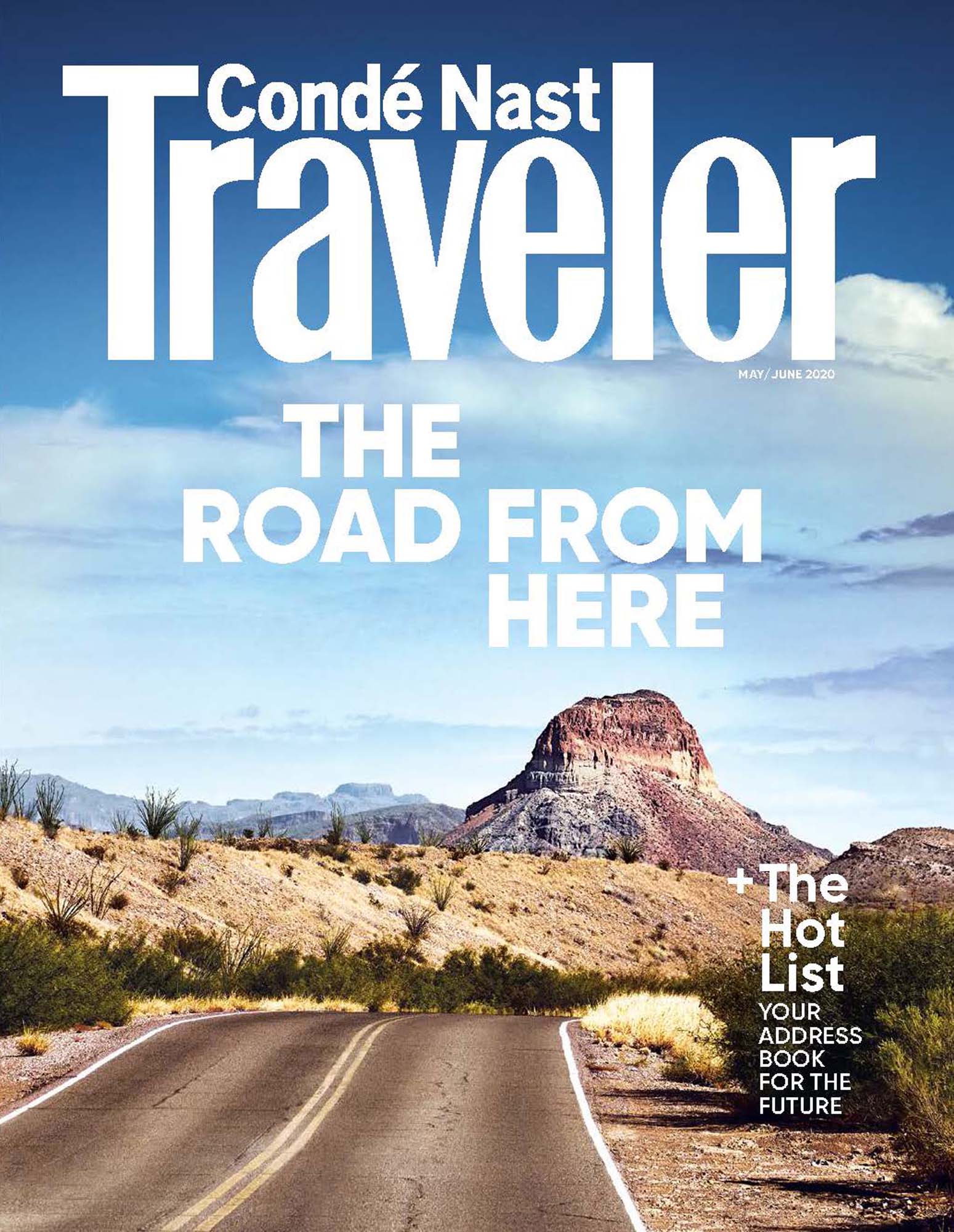Magazine cover featuring the Conde Nast Traveler logo, a desert landscape, and a winding road with a mountain in the background.