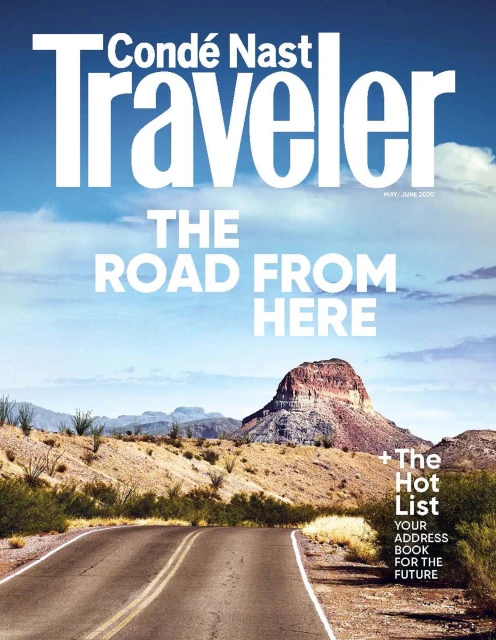 Magazine cover featuring the Conde Nast Traveler logo, a desert landscape, and a winding road with a mountain in the background.