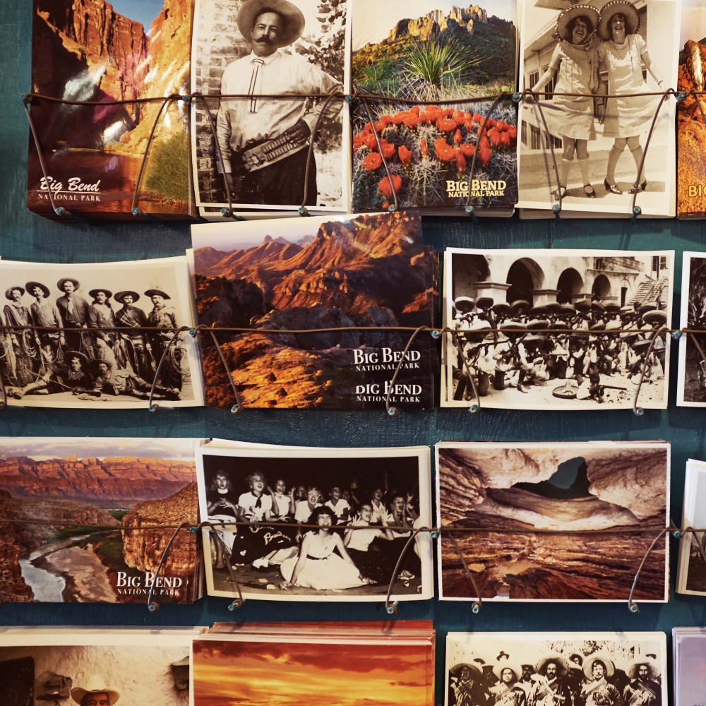 Vintage postcards on display featuring landscape views and people in historical clothing in what appears to be Big Bend National Park.