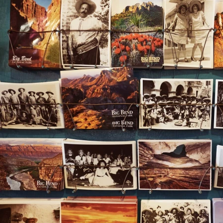 Vintage postcards on display featuring landscape views and people in historical clothing in what appears to be Big Bend National Park.