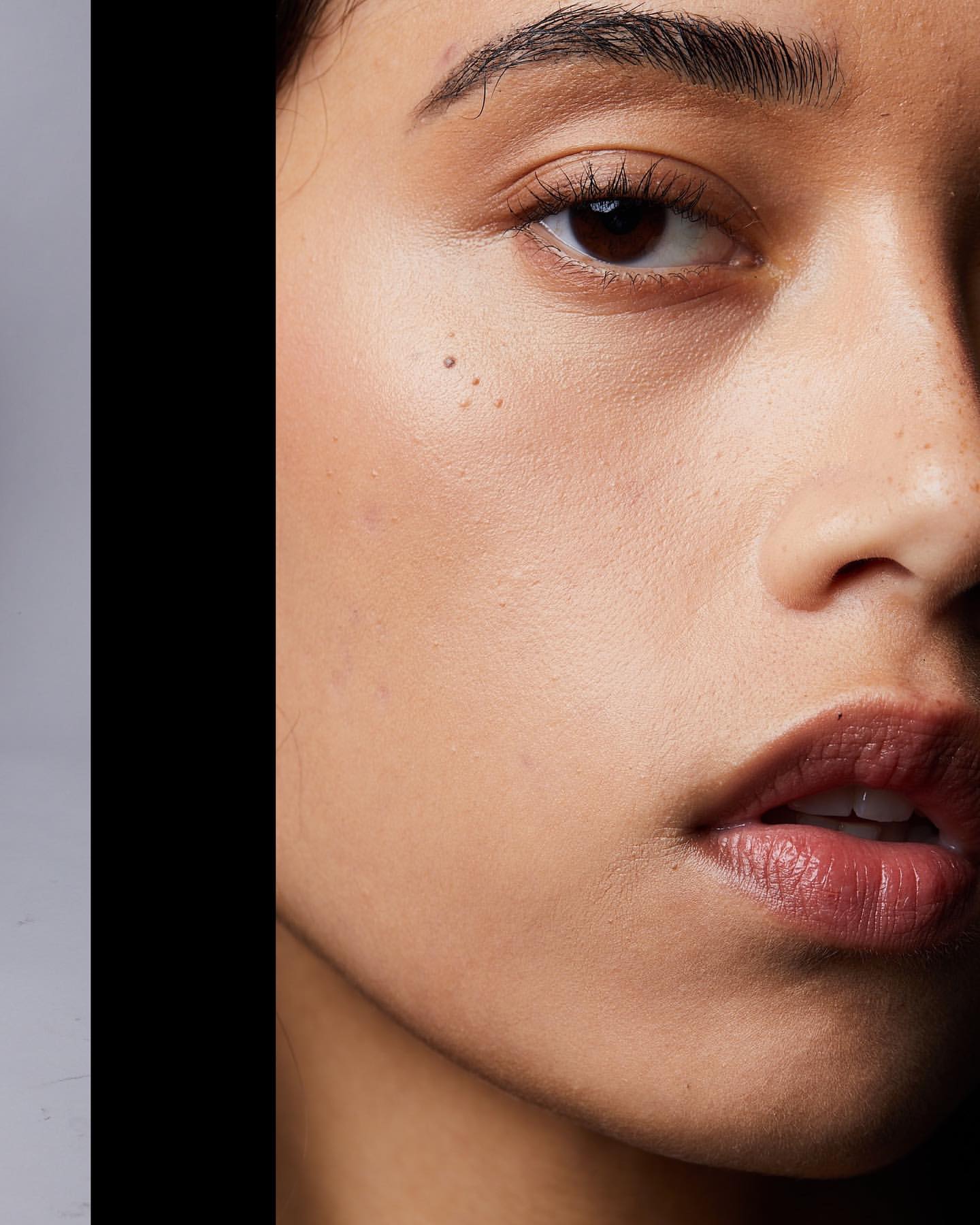 Extreme close-up macro beauty portrait of a woman face focusing on skin texture and lips by photographer Caitlin Mitchell.