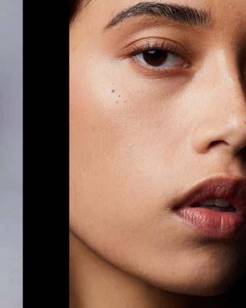 Extreme close-up macro beauty portrait of a woman face focusing on skin texture and lips by photographer Caitlin Mitchell.