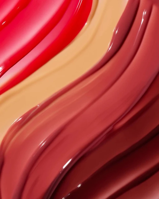 Close-up view of colorful lipstick swatches in shades of red, pink, and beige, showcasing smooth textures and glossy finishes.