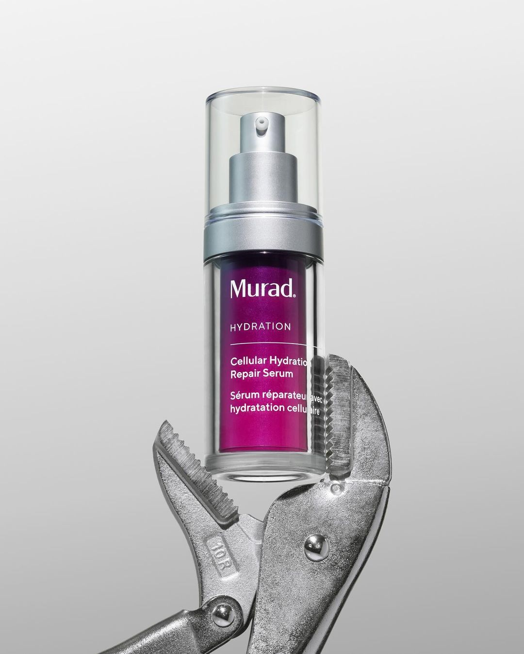 Murad Hydration Cellular Hydration Repair Serum bottle held by metal pliers against a light grey background in a product shot.