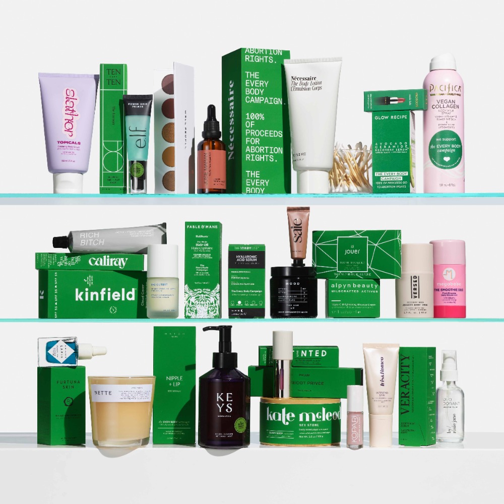 Collection of skincare and cosmetic products on clear shelves, including creams, serums, and cleansing products in green and neutral packaging.