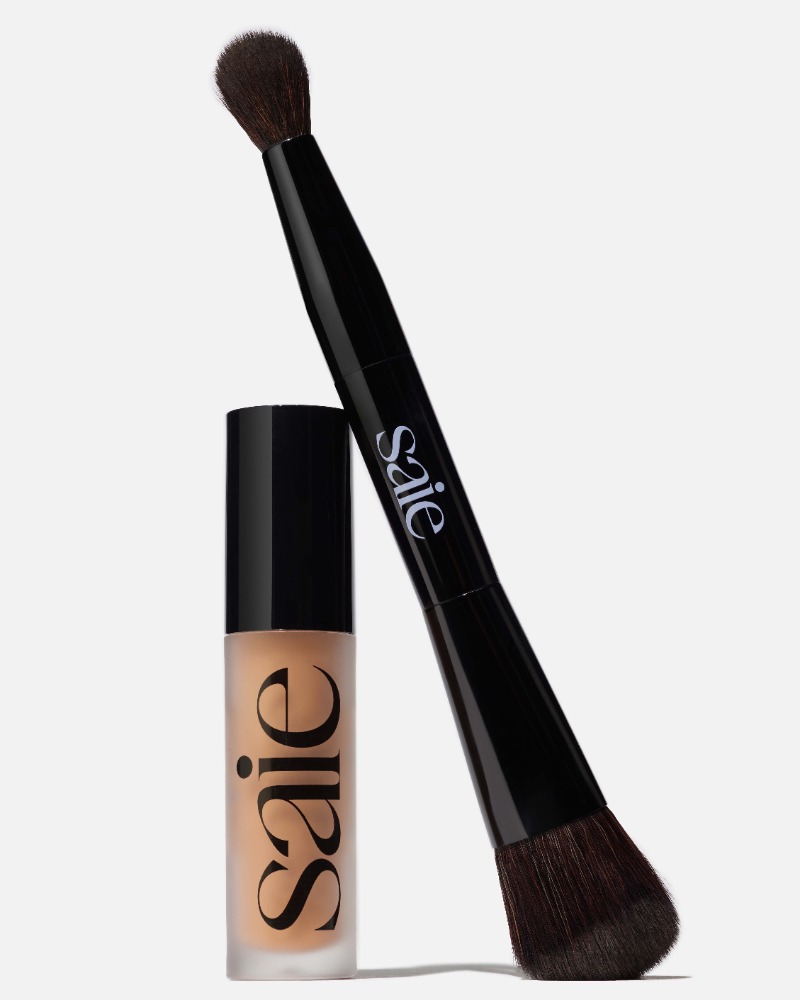 Saie makeup brush and foundation bottle with logo on a white background. Beauty product studio shot for cosmetics advertising.