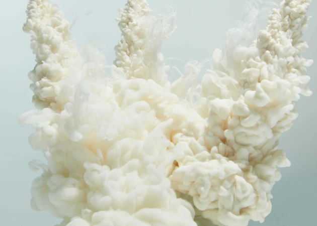 Abstract white smoke plume in a light cyan environment, creating a cloud-like appearance with soft lighting and smooth textures.