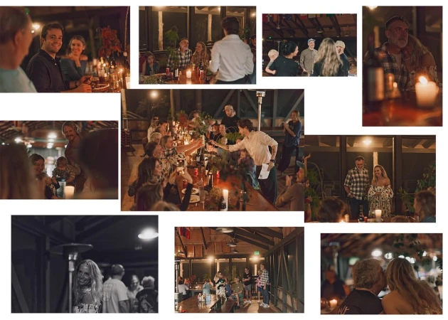 Large group of people at an indoor gathering, seated at a long table with candles, toasting with wine glasses in a warm, dimly lit setting.