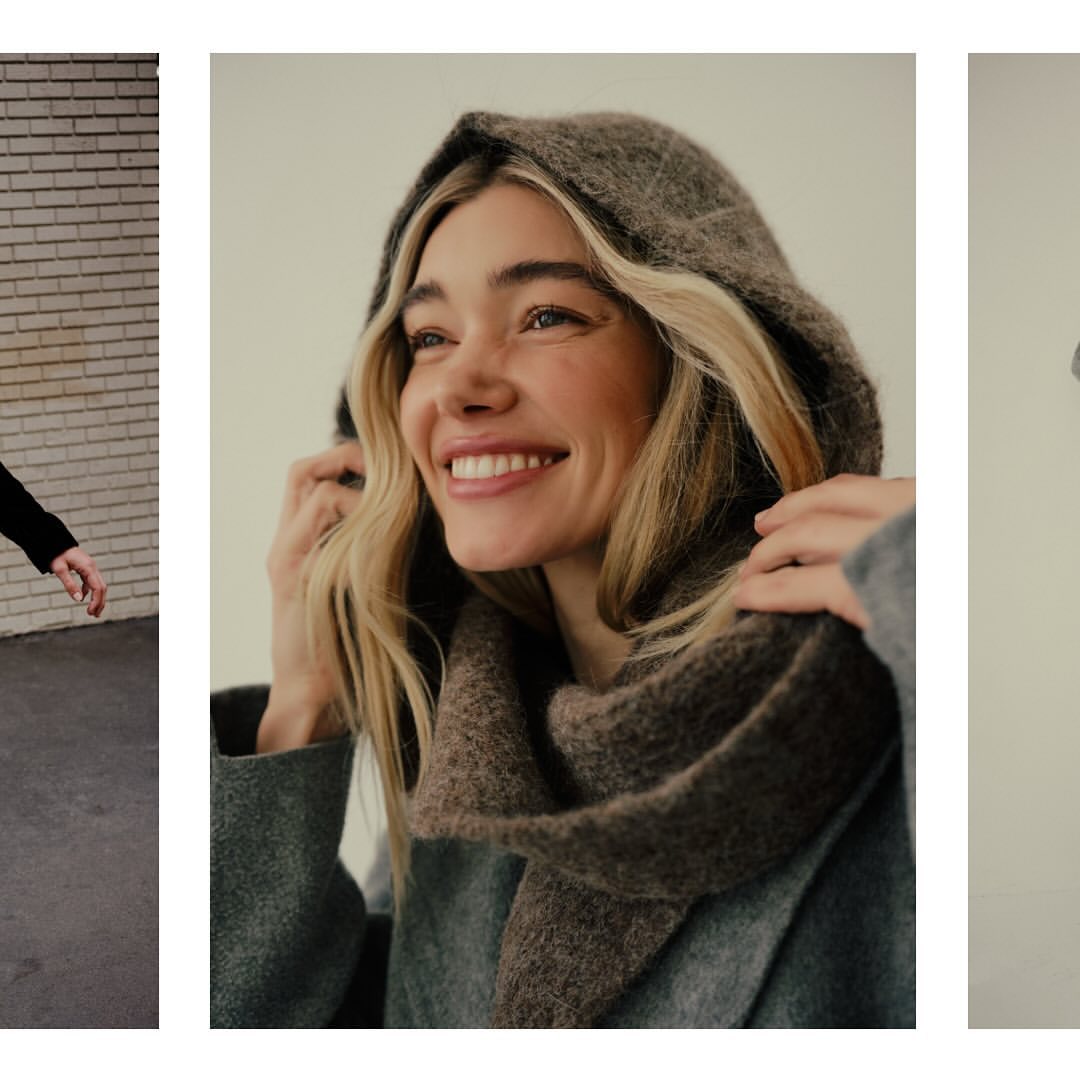 Blonde woman in hooded scarf smiles in a medium shot, wearing a textured gray coat. Studio lighting showcases fashion accessory details.