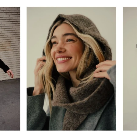 Blonde woman in hooded scarf smiles in a medium shot, wearing a textured gray coat. Studio lighting showcases fashion accessory details.