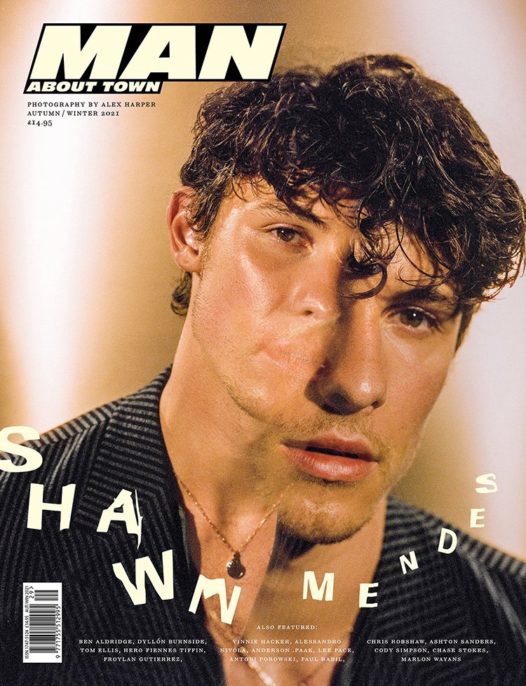 Magazine cover featuring a portrait of Shawn Mendes wearing a jacket, a gold chain necklace, and soft lighting against a blurred background.