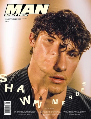 Magazine cover featuring a portrait of Shawn Mendes wearing a jacket, a gold chain necklace, and soft lighting against a blurred background.