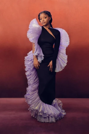 Halle Bailey in a black evening gown with sculptural lavender ruffled trim by photographer Alex G. Harper.