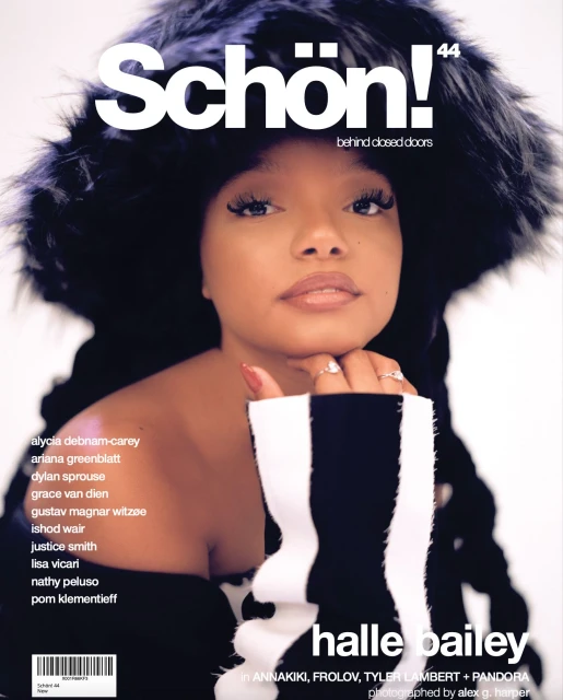 Magazine cover featuring Halle Bailey, wearing a black fur hat, a black and white sweater, with makeup and jewelry, against white backdrop.